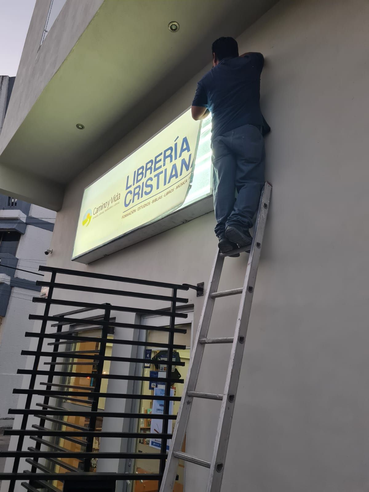Técnico instalando caja de luz en fachada